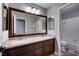 Bright bathroom featuring a large mirror over double sinks and a shower/tub combination at 8944 Campanella St, Las Vegas, NV 89123