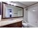 Well-lit bathroom with vanity, granite countertop, and a bathtub with a shower at 8944 Campanella St, Las Vegas, NV 89123