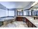 Bright bathroom featuring a soaking tub, granite countertop, double sinks, and dark wood cabinetry at 8944 Campanella St, Las Vegas, NV 89123