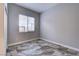 Cozy bedroom with a window offering natural light, complemented by stylish floor tiling at 8944 Campanella St, Las Vegas, NV 89123