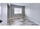 Neutral bedroom featuring a window, base trim, and beautiful tile flooring at 8944 Campanella St, Las Vegas, NV 89123