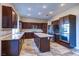 Beautiful kitchen with stainless steel appliances, granite counters, a center island, and dark wood cabinetry at 8944 Campanella St, Las Vegas, NV 89123