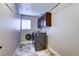 Functional laundry room with modern washer and dryer, cabinetry and tiled floor at 8944 Campanella St, Las Vegas, NV 89123