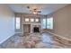 Spacious living room with a fireplace and large windows, providing ample natural light at 8944 Campanella St, Las Vegas, NV 89123