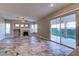Open living area featuring tile floors, fireplace, backyard access, and abundant natural light at 8944 Campanella St, Las Vegas, NV 89123