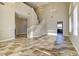 Open-concept living area boasts tall ceilings, tile flooring, and a staircase leading to the upper level at 8944 Campanella St, Las Vegas, NV 89123