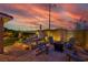 Cozy backyard patio featuring comfortable seating, a fire pit, and string lights, perfect for evening gatherings at 8944 Campanella St, Las Vegas, NV 89123