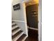Half bath by the stairway with wood floors and floating shelves, offering style and convenience at 898 Flagstone Way, Las Vegas, NV 89110