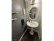 Powder room showcasing a pedestal sink, decorative mirror, and stylish wall decor for an elegant touch at 898 Flagstone Way, Las Vegas, NV 89110