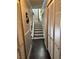 Hallway view with stairs, and white shuttered doors, offering plenty of storage space at 898 Flagstone Way, Las Vegas, NV 89110