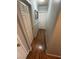 Hallway with wood-look flooring, neutral paint, and white doors leading to various rooms at 898 Flagstone Way, Las Vegas, NV 89110
