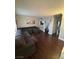 Spacious living room featuring a comfortable sectional sofa and dark, attractive hardwood flooring at 898 Flagstone Way, Las Vegas, NV 89110