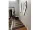 View of carpeted stairs with white banister and decorative wall hangings at 898 Flagstone Way, Las Vegas, NV 89110
