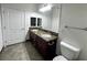 Bathroom with double sinks, dark wood cabinetry, and a framed mirror above at 8985 S Durango Dr # 1010, Las Vegas, NV 89113