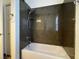 Modern tub with granite surrounding, sleek shower head, and neutral wall color at 8985 S Durango Dr # 1010, Las Vegas, NV 89113