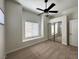 Bedroom features ceiling fan, carpeted floor, window with blinds and mirrored closet at 8985 S Durango Dr # 1010, Las Vegas, NV 89113