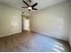 Spacious bedroom with carpet, ceiling fan and ensuite door with a view into the ensuite at 8985 S Durango Dr # 1010, Las Vegas, NV 89113