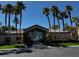 Exterior view of the Sunset Cliffs clubhouse, surrounded by palm trees and manicured lawns at 8985 S Durango Dr # 1010, Las Vegas, NV 89113