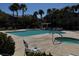 View of the community pool area featuring a spacious pool, hot tub, lounge chairs and lush landscaping at 8985 S Durango Dr # 1010, Las Vegas, NV 89113