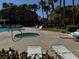 View of the community pool area featuring a jacuzzi, lounge chairs, palm trees, and condo buildings in the background at 8985 S Durango Dr # 1010, Las Vegas, NV 89113