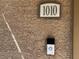 Modern doorbell and door number on a textured wall at 8985 S Durango Dr # 1010, Las Vegas, NV 89113