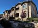 Exterior view of a multi-story condo building with neutral tones and landscaped grounds under a bright blue sky at 8985 S Durango Dr # 1010, Las Vegas, NV 89113
