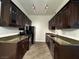 Galley kitchen featuring rich wood cabinetry, granite countertops and stainless steel appliances at 8985 S Durango Dr # 1010, Las Vegas, NV 89113