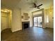 Bright living room featuring a modern ceiling fan, fireplace, and access to outdoor patio at 8985 S Durango Dr # 1010, Las Vegas, NV 89113