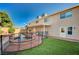 Backyard featuring a pool, jacuzzi, artificial grass and concrete patio at 902 Dianne Dr, Boulder City, NV 89005