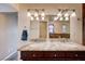 Bright bathroom featuring double sinks, marble countertops, and modern lighting fixtures at 902 Dianne Dr, Boulder City, NV 89005