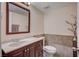 Bathroom with modern fixtures, dark wood cabinets, tiled walls, and a large mirror at 902 Dianne Dr, Boulder City, NV 89005