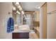 Bright bathroom featuring a glass shower, dual sinks, and modern fixtures at 902 Dianne Dr, Boulder City, NV 89005
