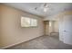 Bedroom view with carpet flooring, standard closet with sliding mirrored doors, ceiling fan, and window at 902 Dianne Dr, Boulder City, NV 89005