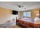 Bedroom with a ceiling fan, a large window, and a wooden bedframe at 902 Dianne Dr, Boulder City, NV 89005