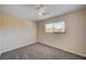 Cozy bedroom with neutral tones, a ceiling fan, carpet flooring, and a window for natural light at 902 Dianne Dr, Boulder City, NV 89005