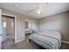 Carpeted bedroom with ceiling fan, closet with mirrored doors and adjacent view to another bedroom at 902 Dianne Dr, Boulder City, NV 89005