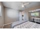 Bedroom featuring neutral walls, ceiling fan, mirrored closet, and door with view of the bathroom at 902 Dianne Dr, Boulder City, NV 89005