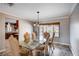 Bright dining area features hardwood floors, a modern chandelier, and backyard views at 902 Dianne Dr, Boulder City, NV 89005