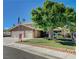 Beautiful home with lush green lawn and mature tree providing ample shade at 902 Dianne Dr, Boulder City, NV 89005