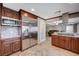 Modern kitchen featuring stainless steel fridge, granite counters, and custom cabinetry at 902 Dianne Dr, Boulder City, NV 89005