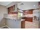 Well-appointed kitchen with counter seating, stone backsplash, and rich, dark wood cabinets at 902 Dianne Dr, Boulder City, NV 89005