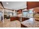 Spacious kitchen with granite counters, stainless steel appliances, and stylish dark wood cabinets at 902 Dianne Dr, Boulder City, NV 89005