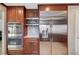 Kitchen featuring stainless steel appliances, custom wood cabinets, and a tile backsplash at 902 Dianne Dr, Boulder City, NV 89005