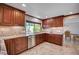 Well-lit kitchen with stainless steel appliances, granite counters, and custom wood cabinets at 902 Dianne Dr, Boulder City, NV 89005