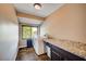 Well-lit laundry room featuring tile flooring, countertop space, modern appliances, and storage options at 902 Dianne Dr, Boulder City, NV 89005