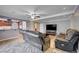A living room featuring a leather couch, ceiling fan, with an open view into the kitchen at 902 Dianne Dr, Boulder City, NV 89005