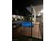 Nighttime pool and hot tub with adjacent covered patio area, perfect for outdoor living at 902 Dianne Dr, Boulder City, NV 89005