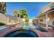 Beautiful backyard pool and spa surrounded by mature landscaping, ideal for relaxation and recreation at 902 Dianne Dr, Boulder City, NV 89005