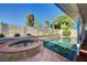 Backyard pool and spa surrounded by mature landscaping, ideal for relaxation and recreation at 902 Dianne Dr, Boulder City, NV 89005