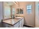 Well-lit bathroom featuring a large vanity, mirror, and neutral paint at 9066 Hilverson Ave, Las Vegas, NV 89148
